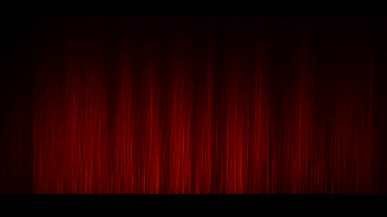 A frame from the trailer — golden letters spelling VALOR rising out of a dark, fractured world