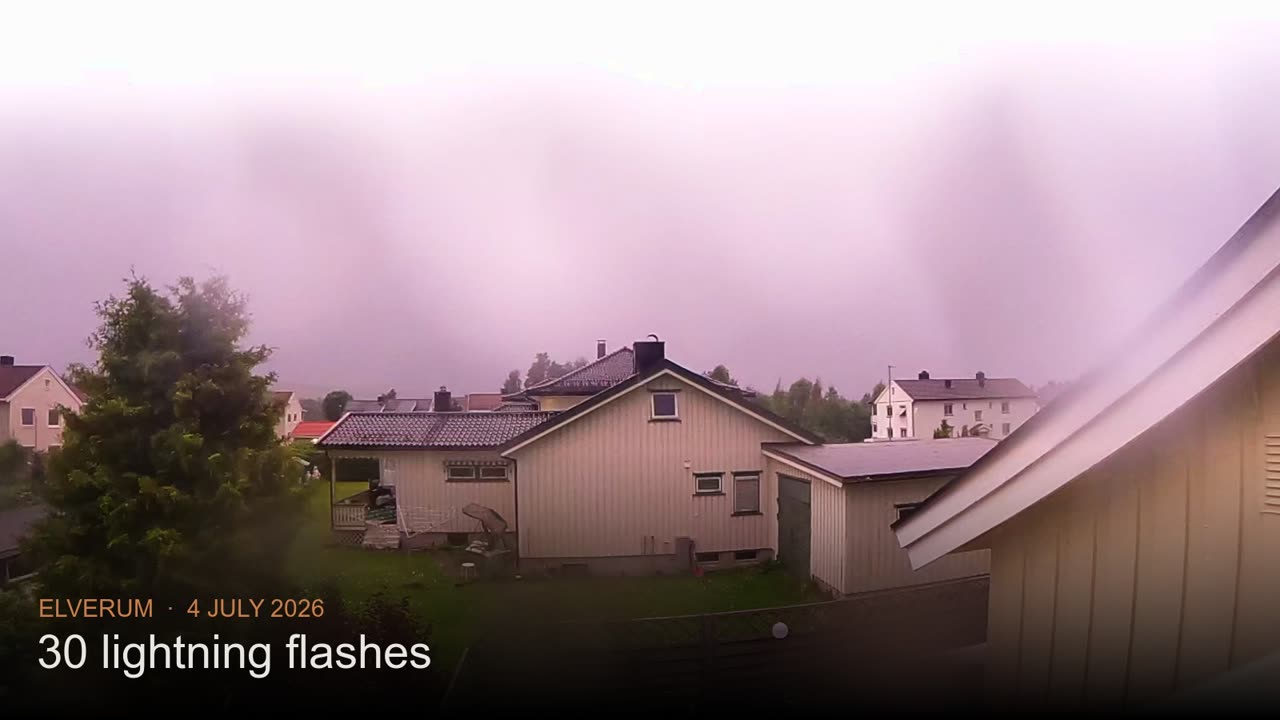 A storm-lit sky over Elverum, the neighbourhood glowing under the clouds